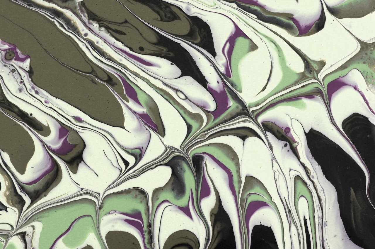brand-02 Dynamic swirls of green and purple acrylic paint create an abstract, marbled effect.