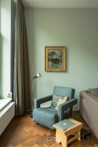 Home interior with chair and lamp by the window